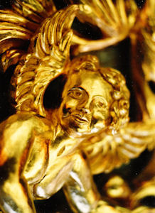 Close up of carved angel face, Cherub for ASU, carved wood sculpture