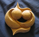 Hand-held meditation carving titled Two Heads Touching with Intertwined Hearts